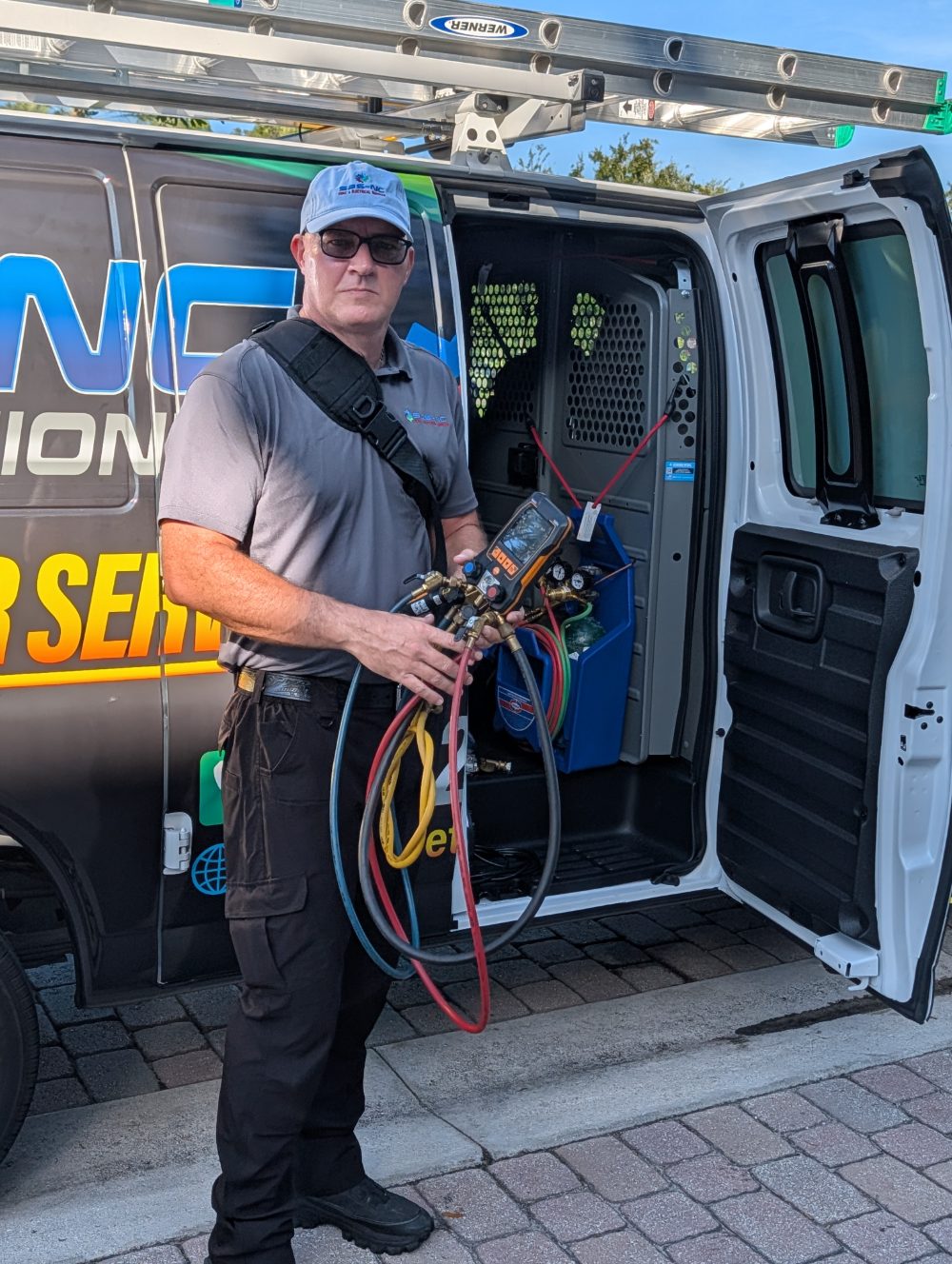 An SBS-NC technician with digital manifold gauges at his stocked service van